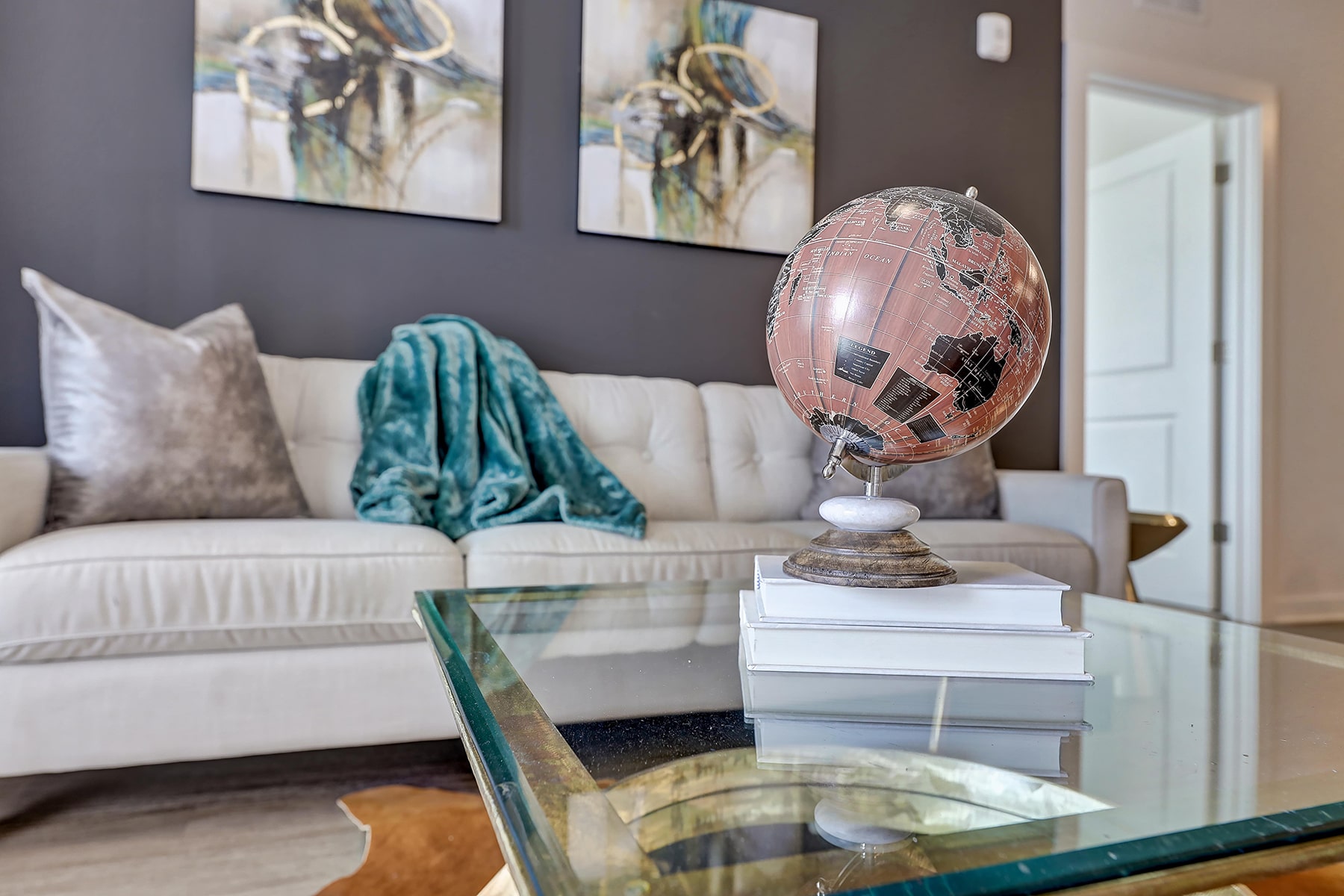 Sofa with coffee table, a globe and two paintings