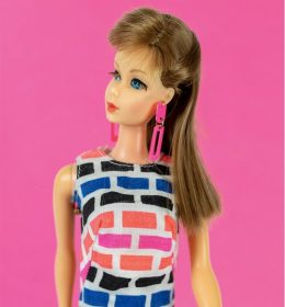 Photo of a doll in a pink background